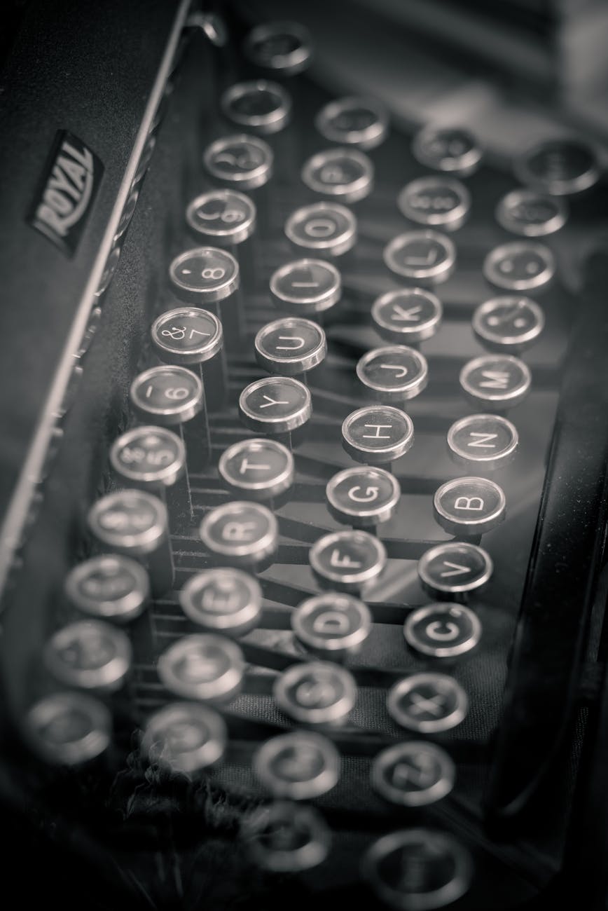 Close-up of vintage typewriter keys in monochrome, showcasing retro style.
