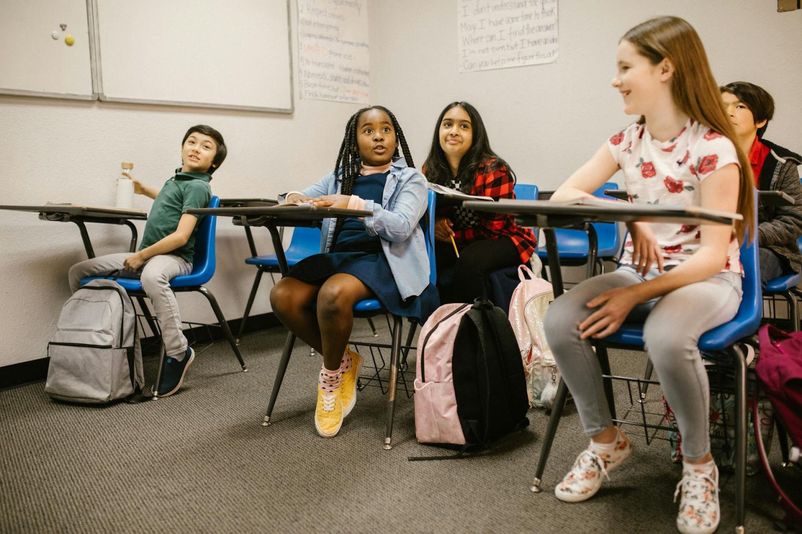 A diverse group of students attentively participating in a classroom setting.