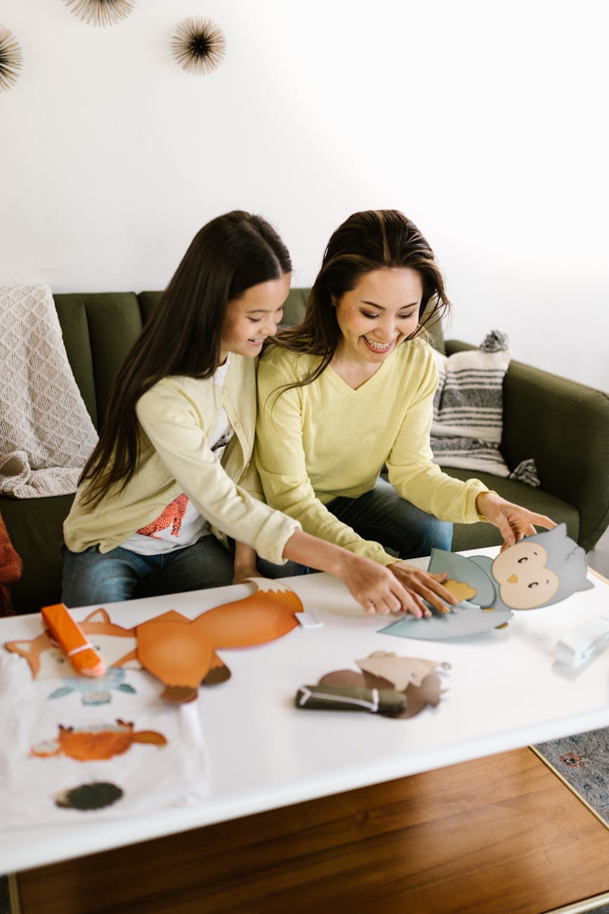 A mother and daughter enjoy a fun craft session together at home, fostering creativity.