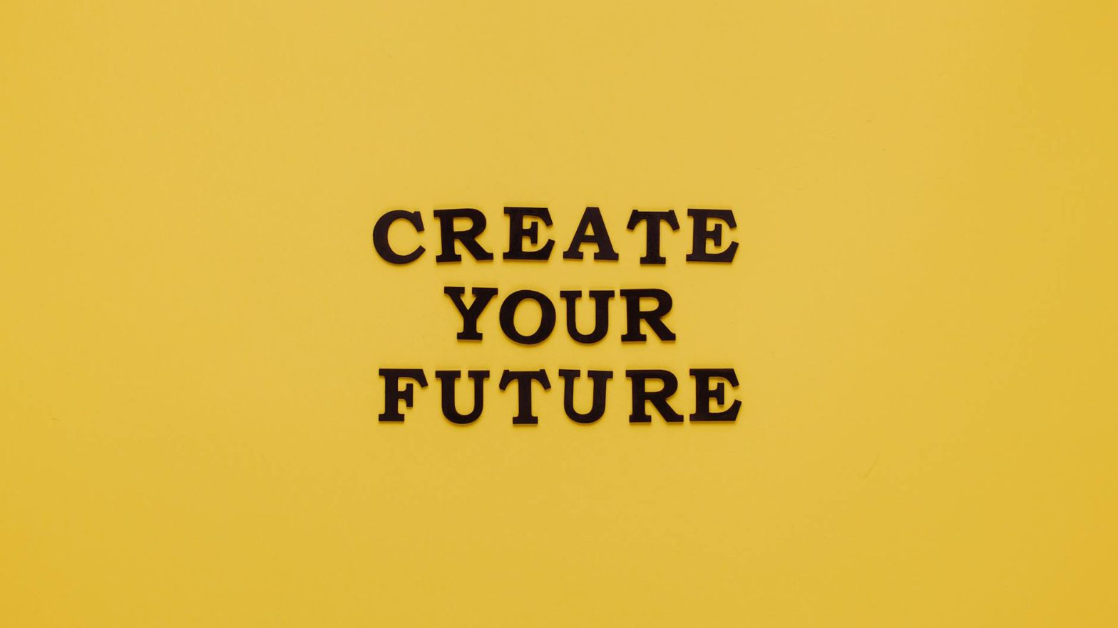 Bold text 'CREATE YOUR FUTURE' on minimalist yellow background. Inspiring design.